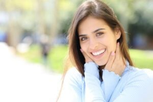 A pretty woman smiling with picture perfect porcelain veneers in Lewisville.