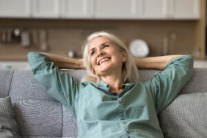 A woman reclining, relaxed from her dentist appointment using oral conscious sedation.